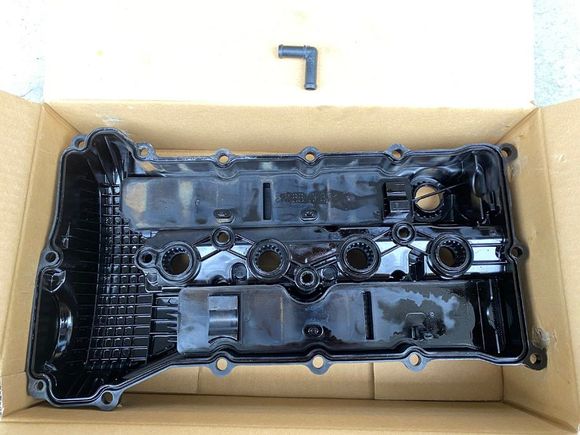 Plastic valve cover (1035A999) removed. So is the stock intake hose's 90° elbow for the 1/2" (12.7mm) breather.