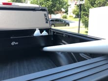 Originally installed as far forward as possible.  4" pipe still fits all the way to front of bed, so definitely can still haul studs or sheets of plywood with tailgate up.  The tonneau cover covers the front 3" of the BakBox, making it impossible to put larger boxes and bags that would otherwise fit into the Bakbox.