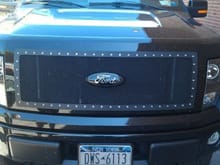 stripped off the old blue ford emblem and put on a new custom metal black emblem cover, then attached the OEM emblem housing onto the new grille

**Those original metal emblems are held on with glue that is stronger than the metal it hold... took forever to rip it off