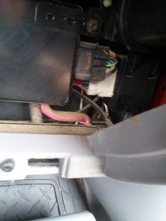 View through glove box, white hose dead center of screen, behind everything else