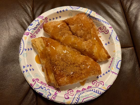 Apple turnovers with caramel sauce and ground cinnamon. Heated, of course!