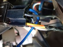This wire goes from the switch to this plug, which is plugged into this breaker or switch or whatever it is. The black wire off this pigtail is ground out on the knee bolster. The white is only 2 inches long and is taped to the yellow/red wire.