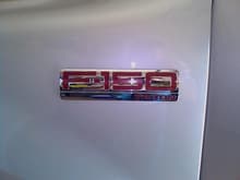 Side emblem with metallic red inset