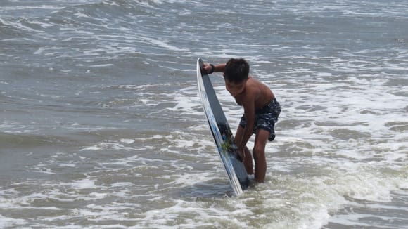 7 yr old grandson and his board...you can't keep this kid out of the water.