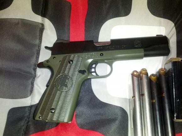 Springfield Custom 1911. Started as a basic mil-spec. I added a STI 4lb trigger, Armory Kote, match grade stainless steel barrell, VZ Molon Labe 'thin' grips, action job and novak night sights.