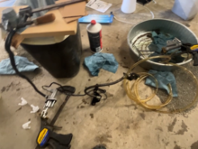 Poor and blurry pic. I bled the whole system off the car, like this. The brake fluid fill container you see in the left side of this pic was used to fill the master cylinder reservoir, by propping it up inside the reservoir using one of those white clips.  This kept it full while I bled it using a hand brake bleeder pump.  Installed in car, used hand bleeder pump two more times at slave cylinder, perfect. 