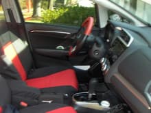 Red and Black seat covers from GT.  Red and Black leather wheel cover from Wheelskins.  Put some color in car!