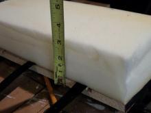 Foam from the cushion of a discarded leather sofa, hot glue was used to affix. Velcro straps can be seen.