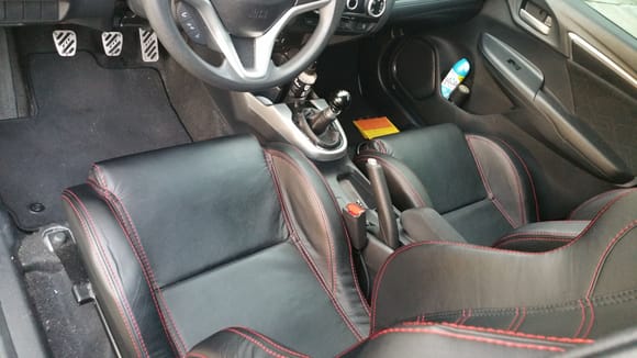 Seats, pedals, and shift knob.