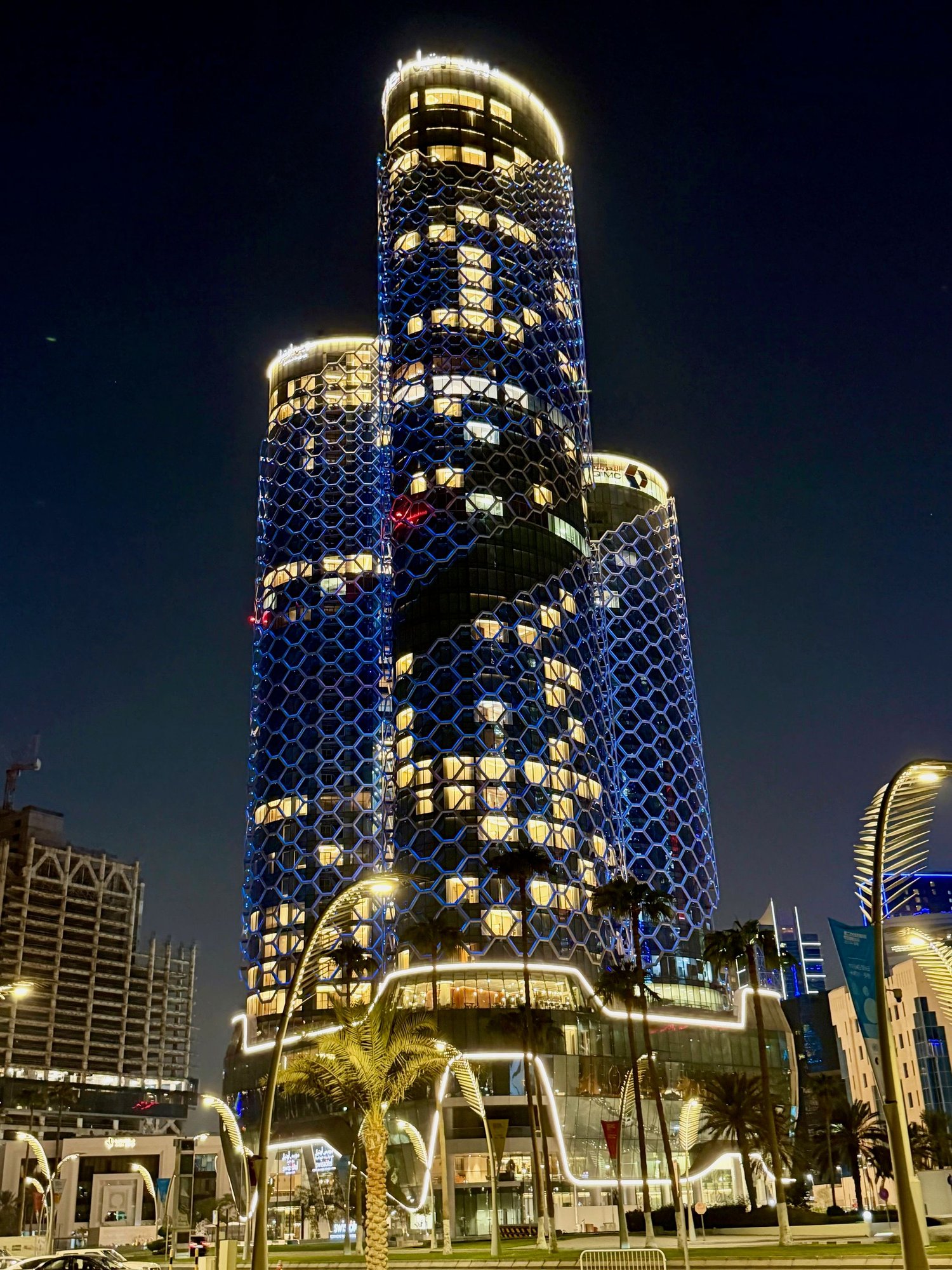 Swissotel towers by night, a view from Doha Corniche - hotel in the middle, residence on the right, and offices on the left side