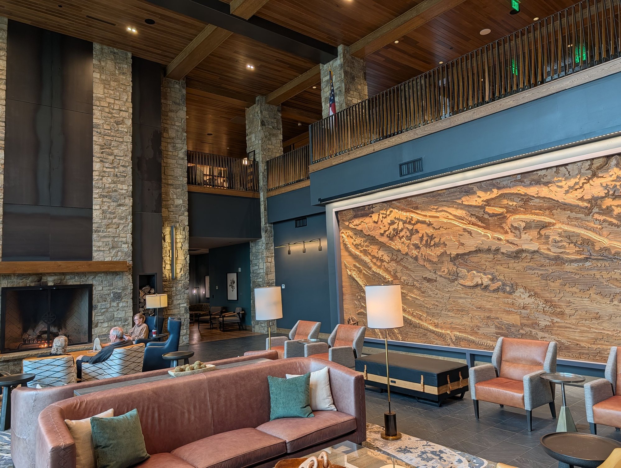 Downstairs sitting area by the fireplace, with a wooden topographical map of the area