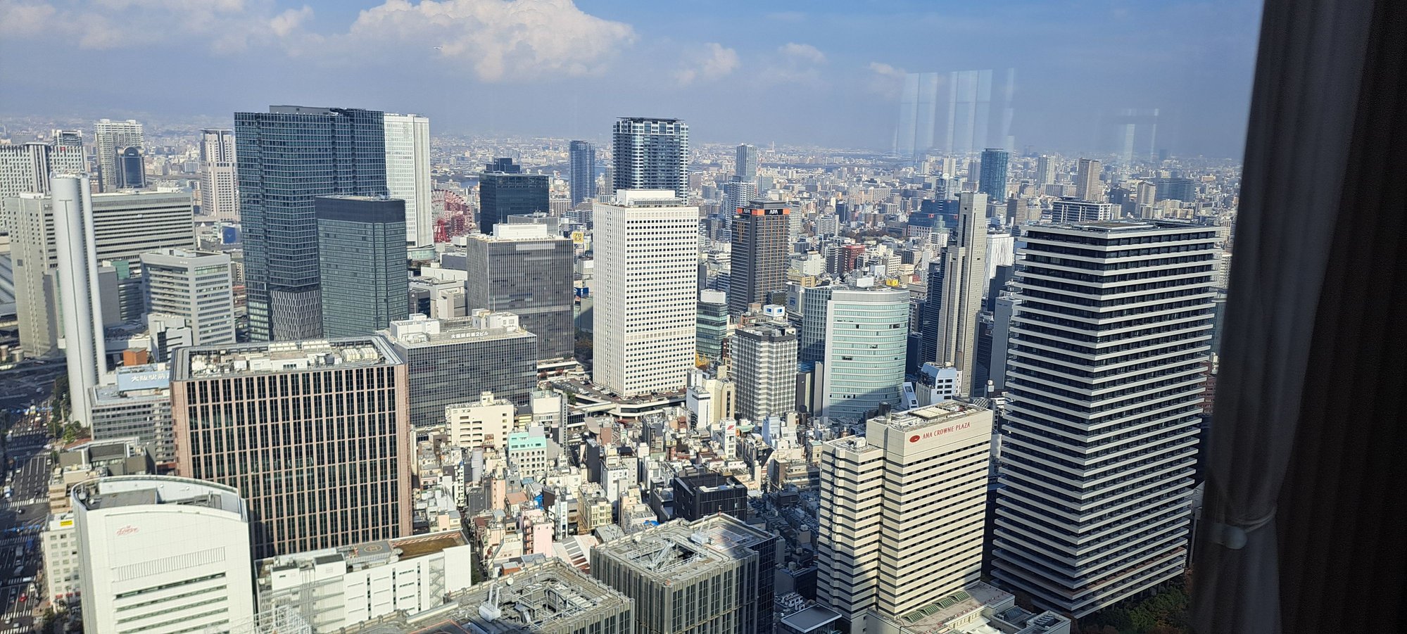 North view towards osaka station. There is a tall building being constructed just across the river with the crane reaching the EL level ( floor 39)