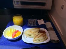 Veggie panini, fruits and a chocolate muffin