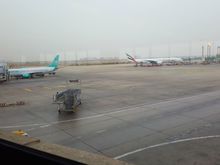 A view of the tarmac. An Emirates 777 heading to Dubai, with 5 daily services from KHI, Emirates has the biggest influence in KHI among international carriers. Towards the domestic side another Serene jet preparing for departure.
