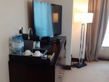 TV with water bottles and Nespresso maker ( glasses and kettle etc in cabinet drawers