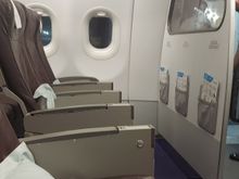 Front row , hardly comfortable with the fixed armrest and note the glazed panel in front of 1AC.