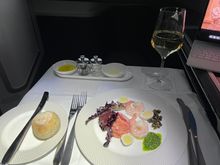 Smoked salmon tartare with poached  shrimp, quail egg, capers, rocket pesto