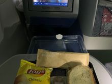 Pastrami sandwich, chips and apple raisin cake dessert