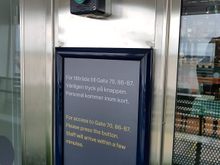 3. Here is the sign on the door, through which you can see a small security station. Press the green button above, which functions as a doorbell.