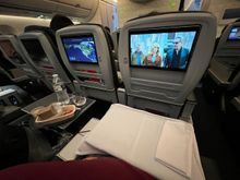 Is two seats/screens/tray tables better than a first class seat?