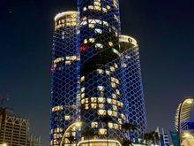 Swissotel towers by night, a view from Doha Corniche - hotel in the middle, residence on the right, and offices on the left side