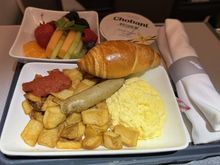 Eggs and accompaniments before landing.  The eggs were quite fluffy.  The fruit bowl was good.