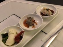 (front to back) feta cheese with lovage pesto and smoked tomato, duck confit with caramelised hazelnut and orange ginger compote, Dorset crab with Oscietra caviar and pumpernickel