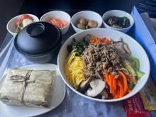Dried pollock soup, kimchi, stir fried shrimp, quail eggs and beef Bibimbap with purple rice. 