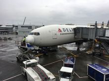 A 777 nose cone open and being looked at in SEA