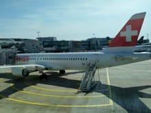 The SWISS plane to Geneva waiting at the gate 