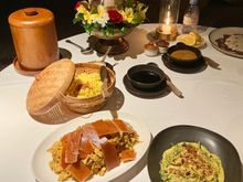 Babi guling and paku gulai / roast pork on spit and forest fern in coconut milk