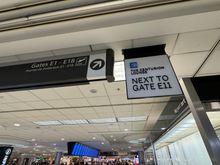 Signs upon coming up the escalator to Term E.