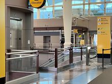 Walk over the west<->east walkway and take the escalator or elevator down to TSA PreCheck.
