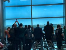 A crowd waiting for the plane 