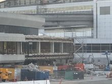 Facade being removed from the 1979 exterior, in the area in front of the Centurion lounge and near the  T3 to -G connector
