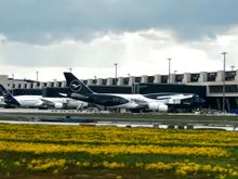 The new Terminal 3 on the south side of the airport with the 100th anniversary colours on a Lufthansa B747-8