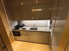 Kitchenette with a microwave, sink, and refrigerator.