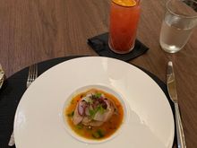Hamachi crudo as the first course; a mocktail in the background 
