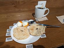 oeufs bouillis au poivre, an authentic SFO lounge bagel, and a few drops of memorial sauce.