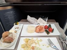 Salmon was uninspiring but acceptable. Larger portion than what I had on the ex-YUL flight last year but very comparable quality. Sides were fine.

I was seated in 1A so entree came out quite quickly.