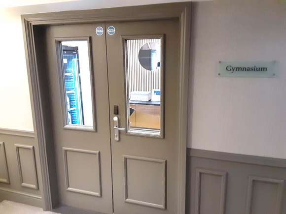 Entry to gym faces elevator right as you step off.