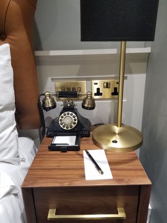 Bedside table with hotel phone