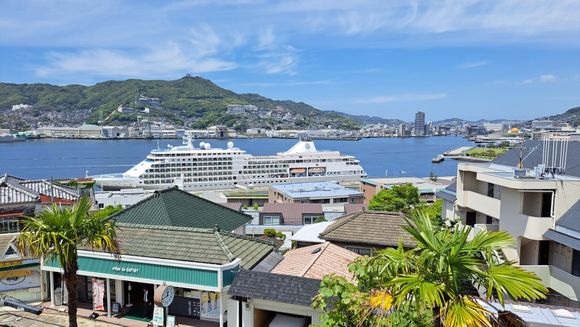 View of the smaller Silversea cruiseship from the lower levels of Glover garden. Mt Inasa to the left  Hilton and Marriott hotels to the right in the distance