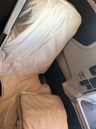 The mattress pads fits over the top of the seat so it doesn't slide down.   I remember years ago the mattress pad on EK didn't have this and it would slide around 