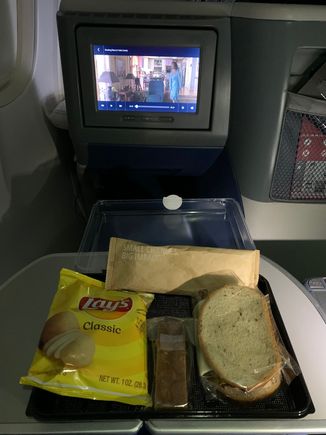 Pastrami sandwich, chips and apple raisin cake dessert