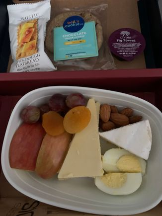 JFK-PLS.  PDB was a mini water bottle. No hot towels. No warm nuts. Snack basket made one appearance but I was in the lavatory. Old plane with tiny IFE screen and very limited choices. 