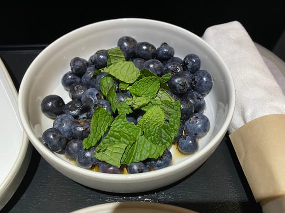 Macerated blueberries.  Refreshing fruit with mint and a touch of honey maybe? 