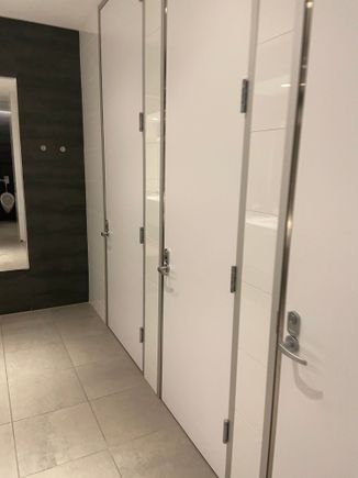 Bathroom has full private stalls. 
