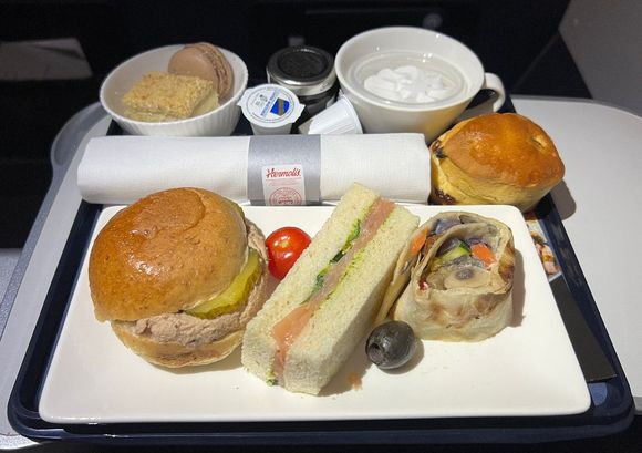 Grilled Vegetables with Hummus Wrap, Finger Sandwich with Smoked Salmon, Rye Roll With Tuna. Scone with Cream.