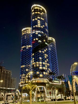 Swissotel towers by night, a view from Doha Corniche - hotel in the middle, residence on the right, and offices on the left side